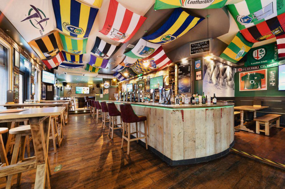 The interior of Shenanigans with flags on the ceiling