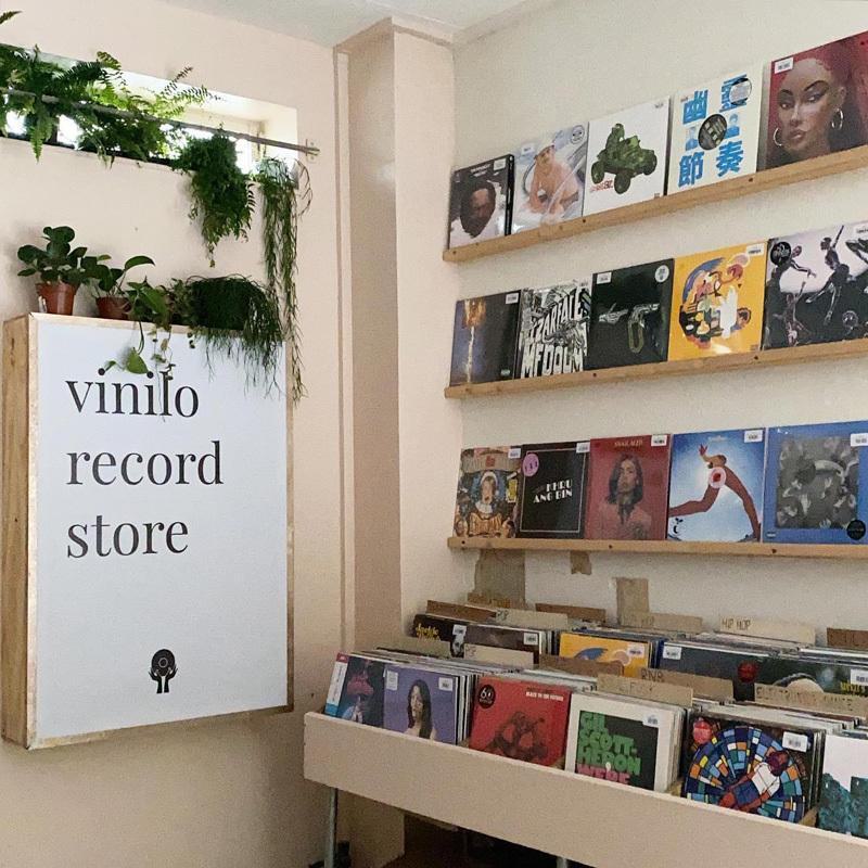 Records displayed on shelves for browsing at the Vinilo Record Store