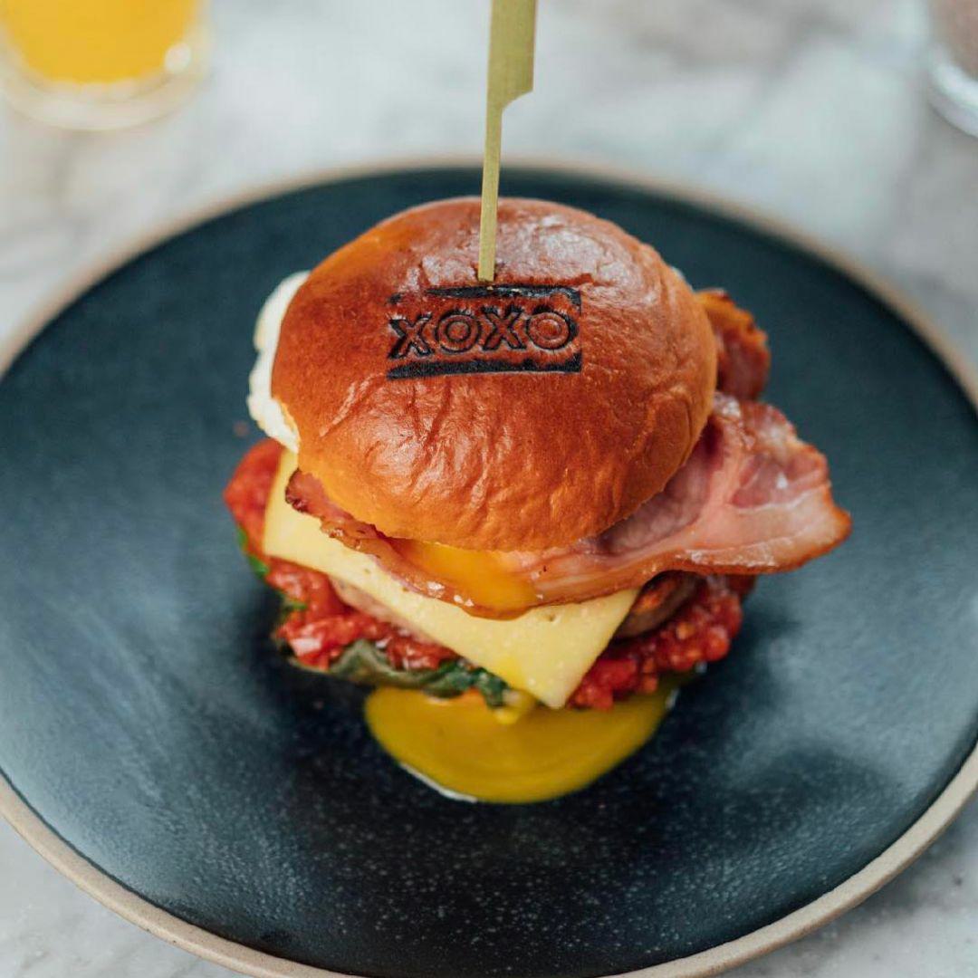 XOXO Brunch burger on dark blue plate