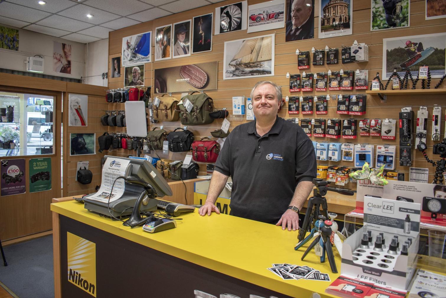 Person behind a counter at London Camera Exchange