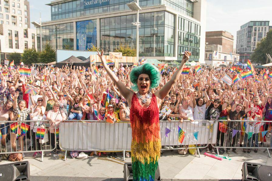 Southampton pride artist on stage with crowd in background