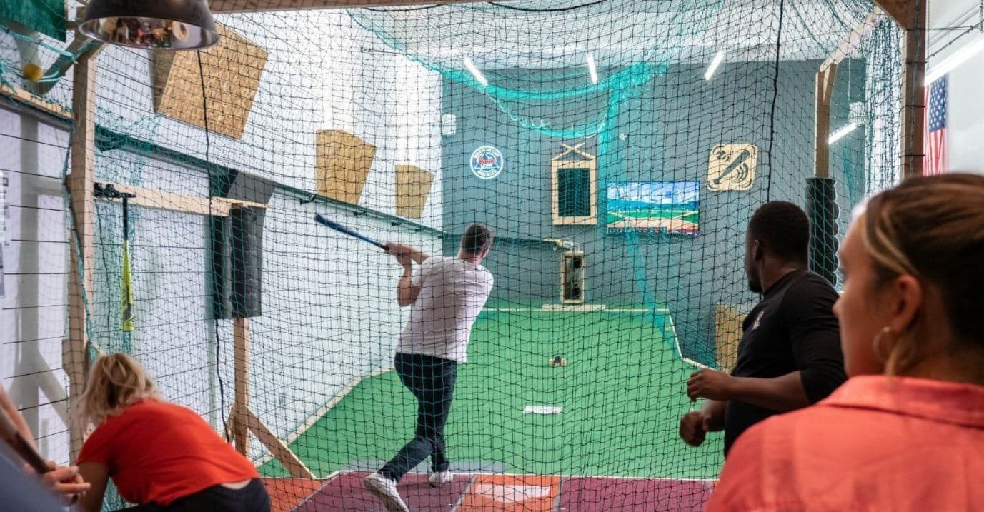 1st Base man hitting a home run at indoor batting cage