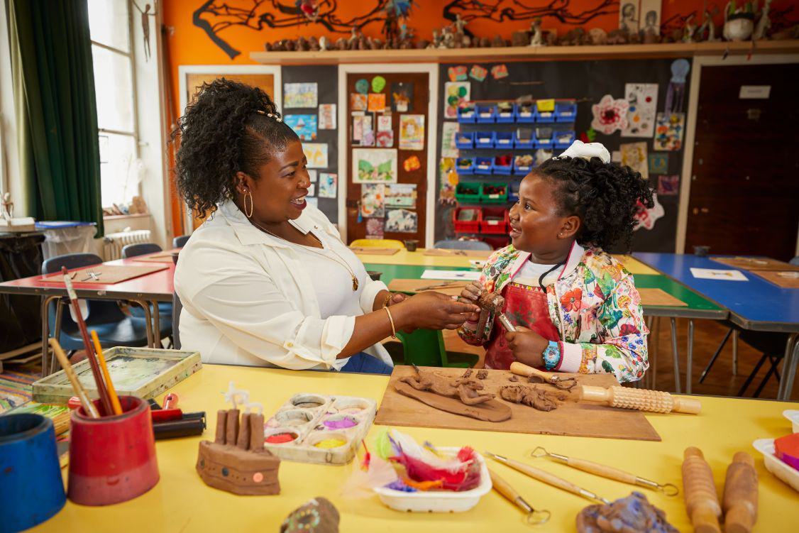 Mother and child making clay sculptures