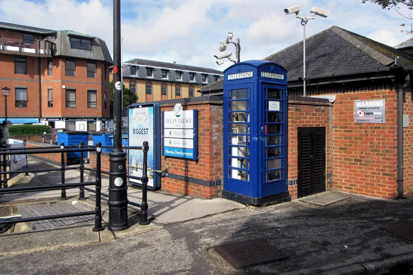 Blue telephone box containing preloved books for a book exchange in Ocean Village