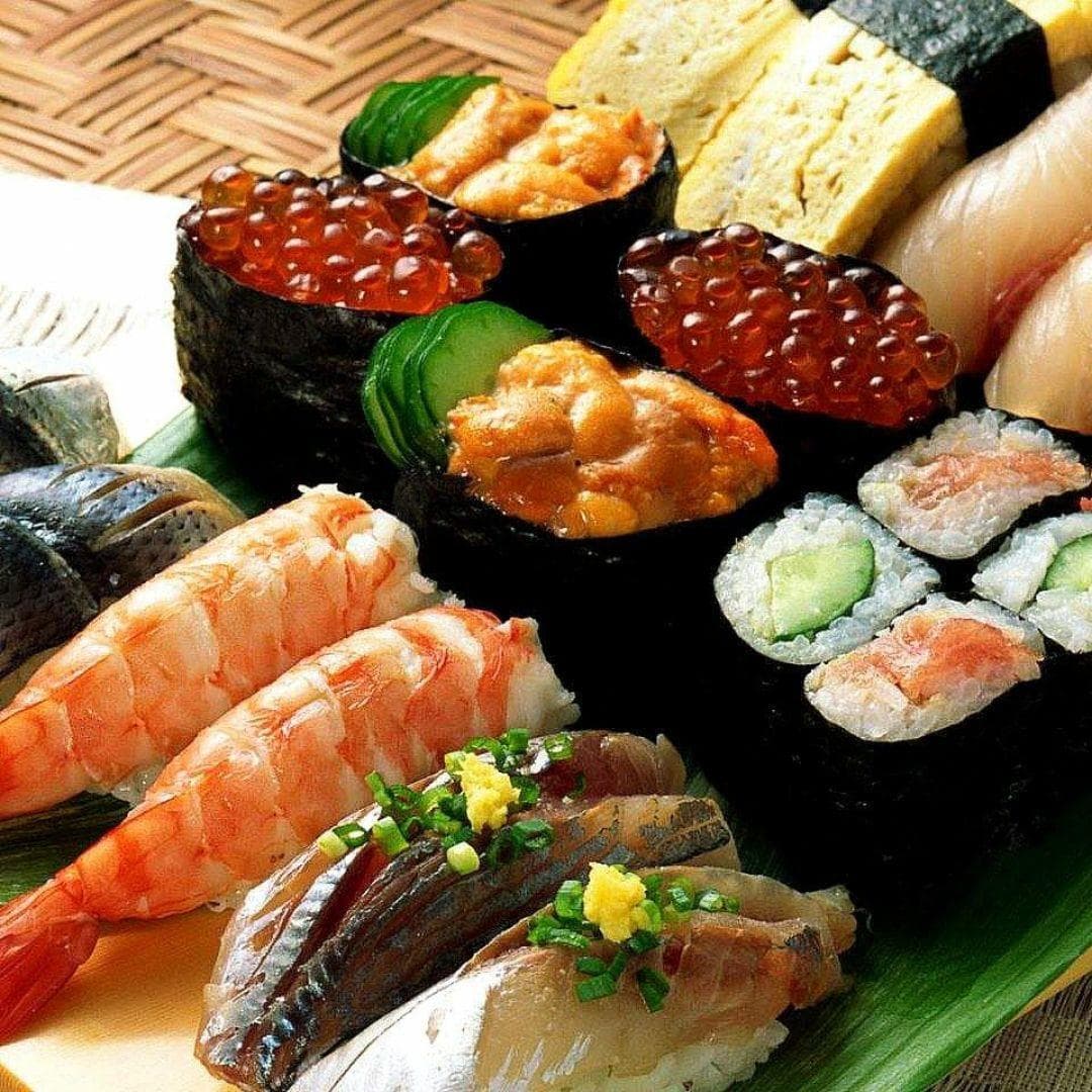 Colourful sushi assortment platter with sashimi shrimp and cucumber rolls from Nara