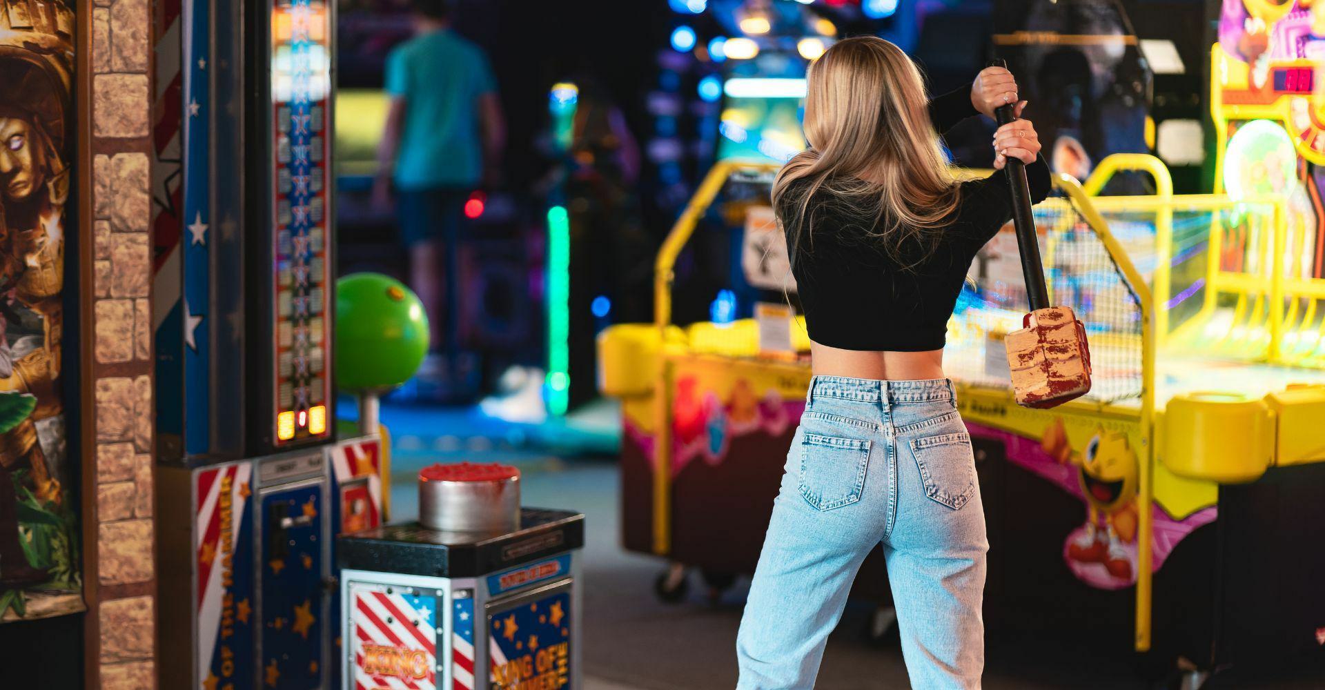 Woman playing hammer game at High Score Arcade