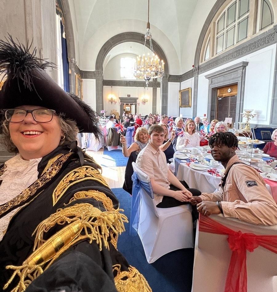 Group of people gathered at tables for the Lord Mayor's Coronation tea party
