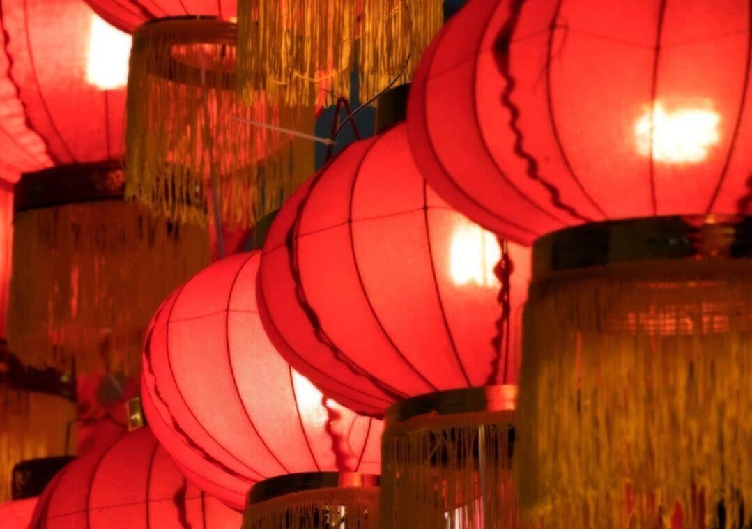 Red paper lanterns with gold tassels hanging from ceiling
