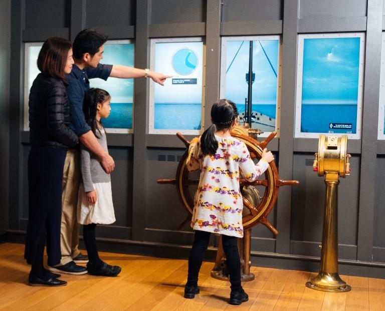 Family looking at an exhibit in SeaCity Museum
