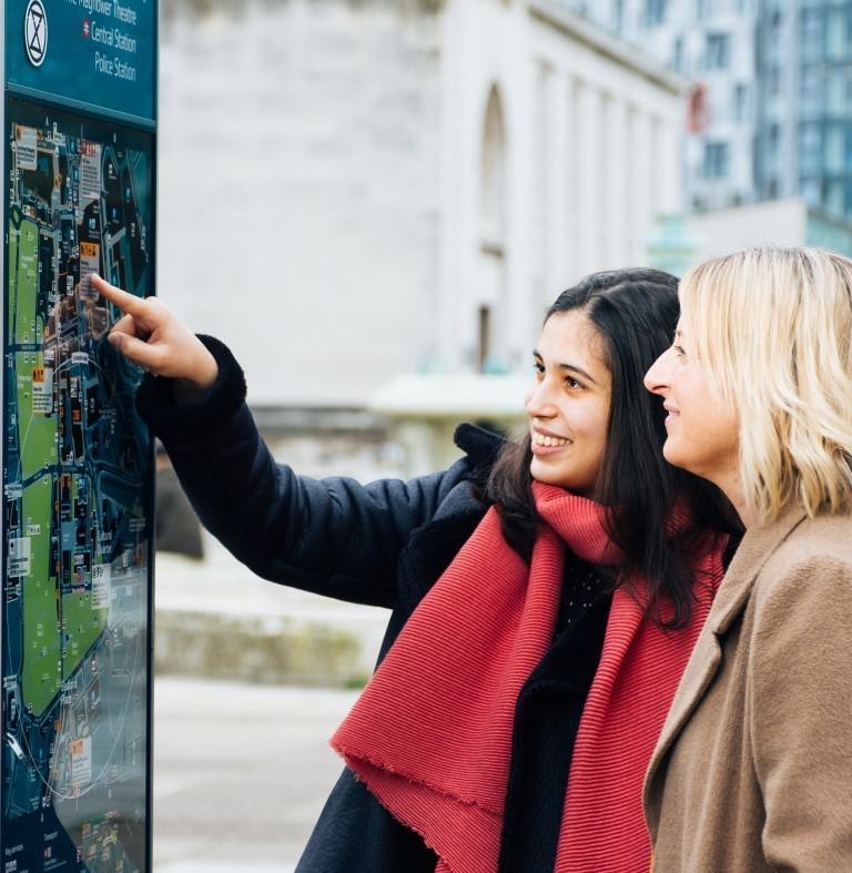 Two ladies looking at a walking map in Southampton