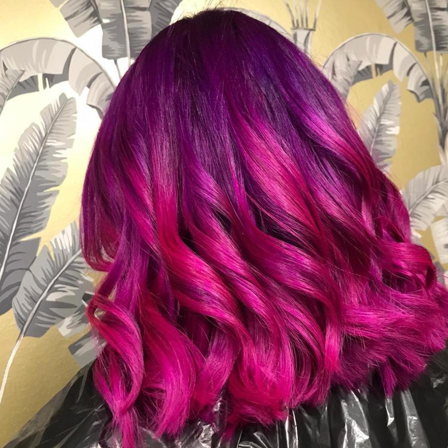 Lady with pink and purple curly hair by Harington hairdressers